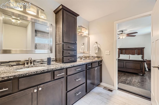 bathroom featuring ceiling fan and vanity