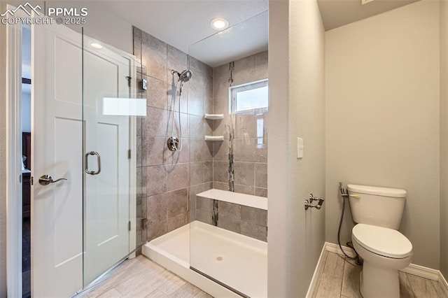 bathroom with toilet and a shower with shower door