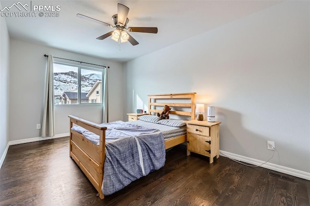 bedroom featuring ceiling fan and dark hardwood / wood-style floors