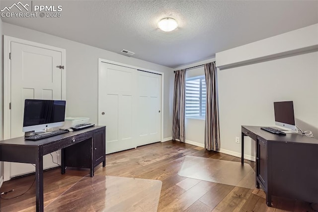 office space featuring hardwood / wood-style flooring and a textured ceiling