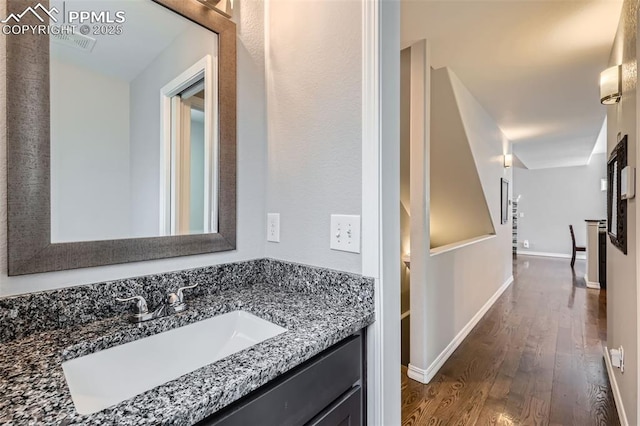 bathroom with hardwood / wood-style flooring and vanity