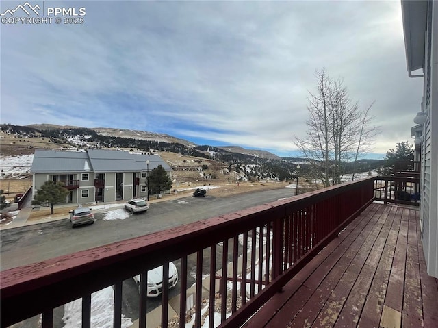 snow covered deck featuring a mountain view