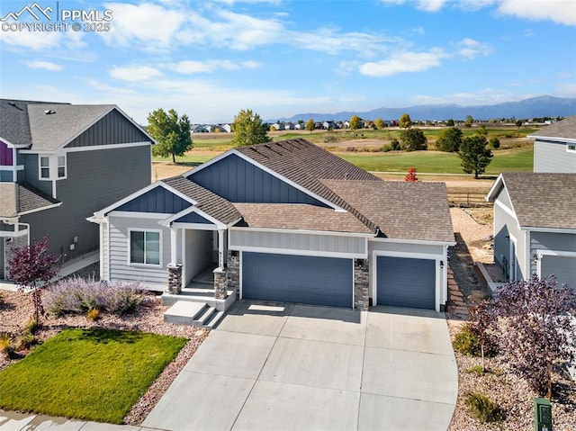 view of front of property featuring a garage and a mountain view