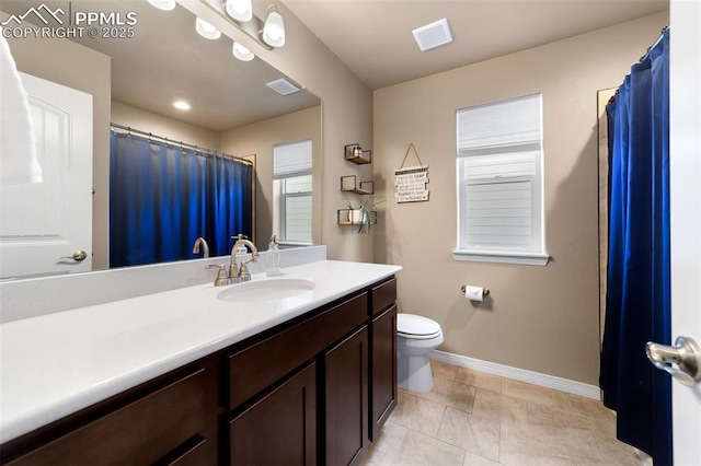 bathroom featuring toilet, vanity, and tile patterned flooring