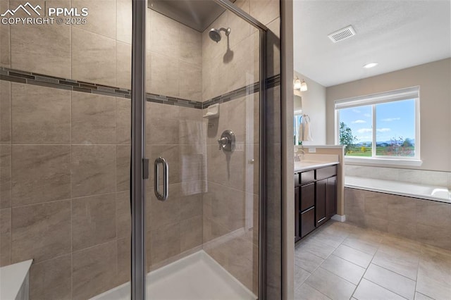 bathroom featuring vanity, tile patterned floors, and walk in shower