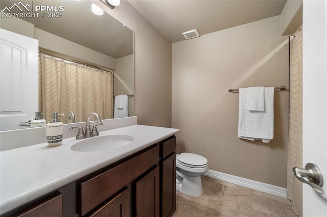 bathroom with toilet and vanity