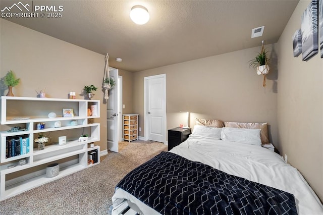 carpeted bedroom with a textured ceiling