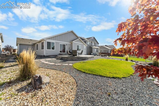 back of house featuring a patio area and a yard