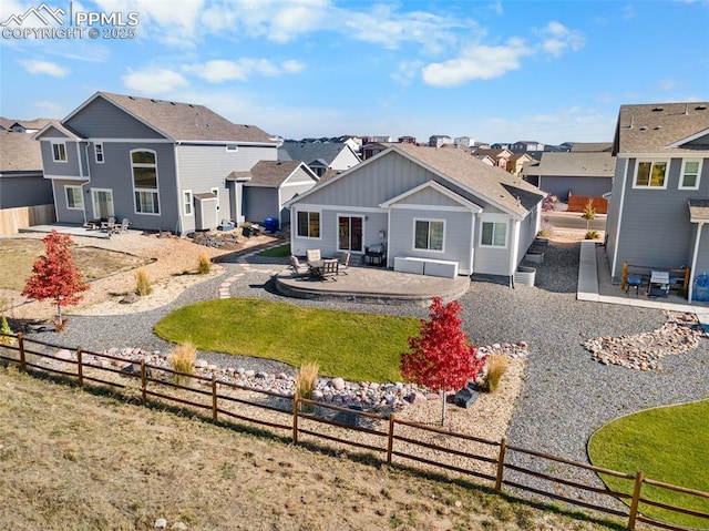 back of house featuring a lawn and a patio area