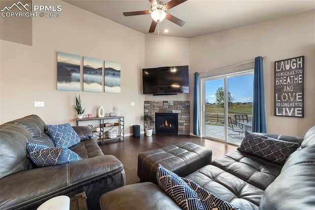 living room with hardwood / wood-style flooring, ceiling fan, and a fireplace