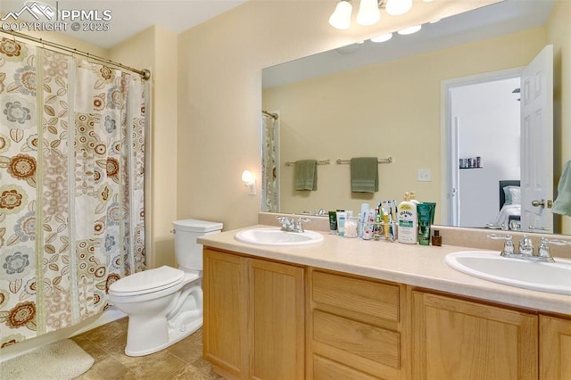 bathroom featuring vanity, tile patterned flooring, and toilet