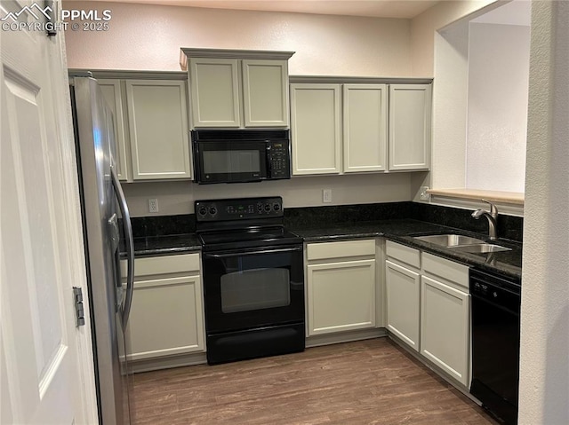 1291 Timber Run Hts, Monument, CO 80132 - kitchen with black appliances, a sink, dark wood-style floors, and a textured wall