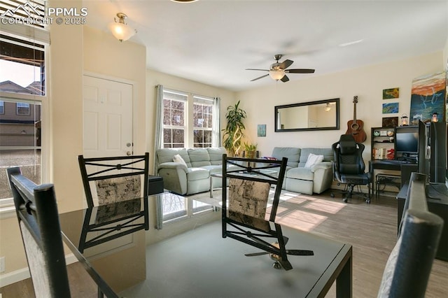 living room featuring ceiling fan, plenty of natural light, and dark hardwood / wood-style floors