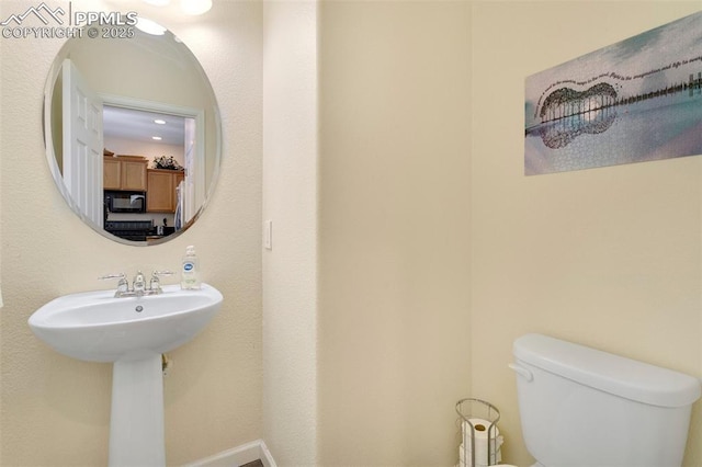 bathroom featuring sink and toilet