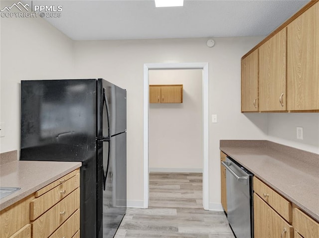 kitchen featuring light brown cabinetry, dishwasher, light hardwood / wood-style floors, and black fridge