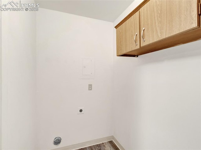 laundry room with cabinets, hardwood / wood-style floors, and electric dryer hookup