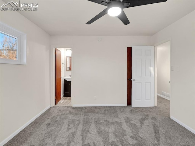 unfurnished bedroom featuring ceiling fan, connected bathroom, and light colored carpet