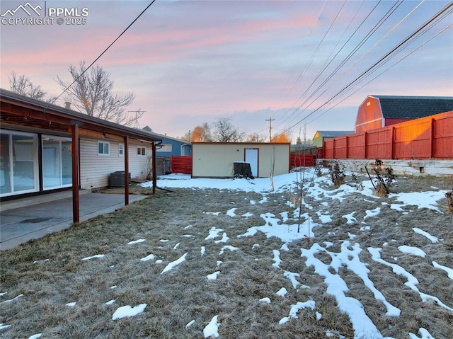 yard covered in snow featuring central air condition unit and an outdoor structure