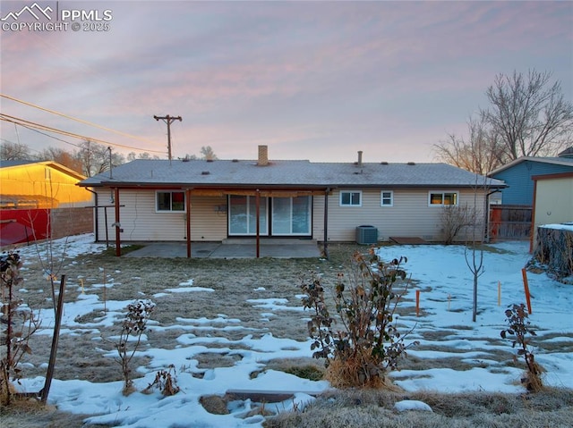 snow covered property with a patio area and cooling unit