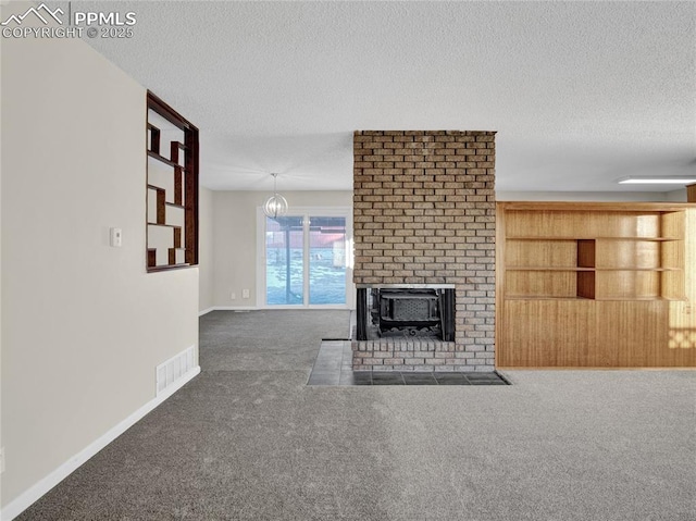 unfurnished living room featuring a textured ceiling, dark colored carpet, and a fireplace