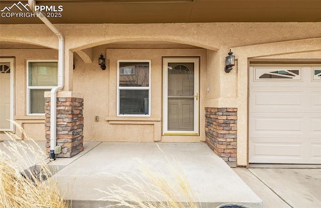 view of exterior entry featuring a garage