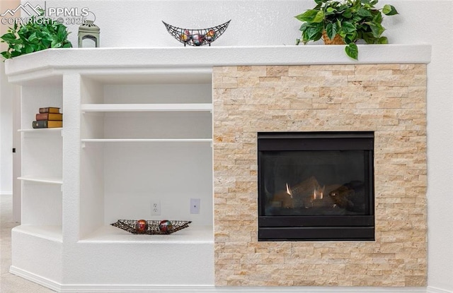 interior details with built in shelves and a tile fireplace