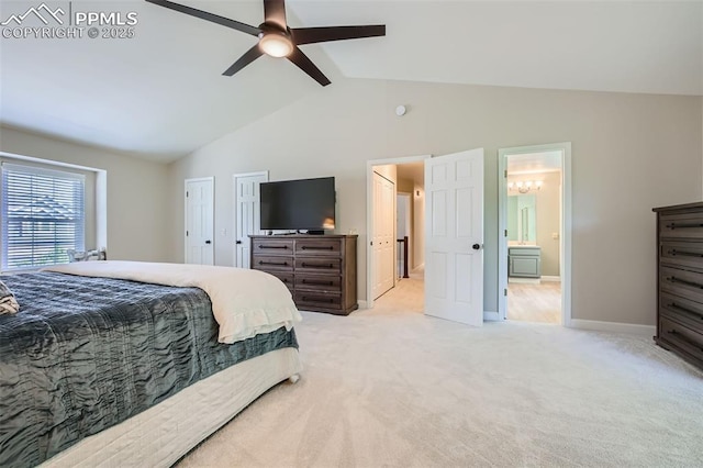 bedroom featuring ceiling fan, light colored carpet, ensuite bathroom, and lofted ceiling