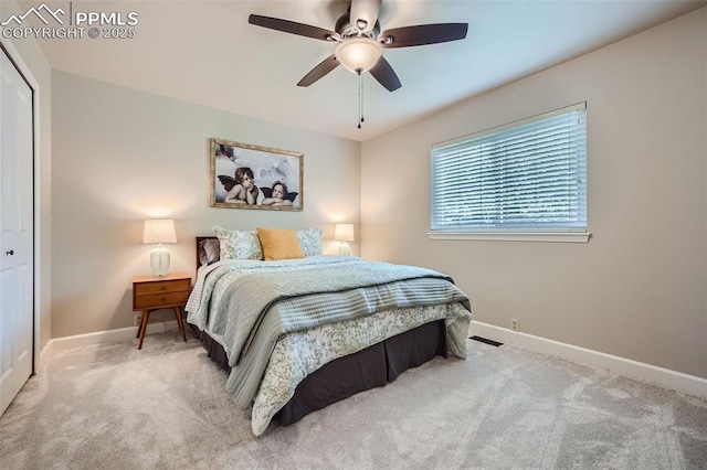 bedroom featuring ceiling fan, a closet, and light carpet