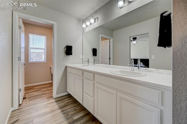 bathroom with vanity, wood-type flooring, and toilet