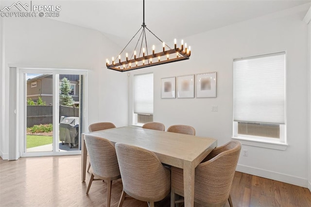 dining space featuring hardwood / wood-style floors and a notable chandelier