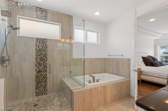 bathroom with shower with separate bathtub