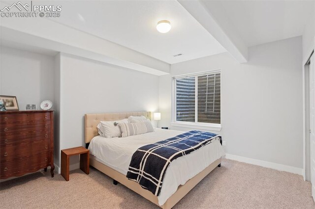 carpeted bedroom featuring beam ceiling