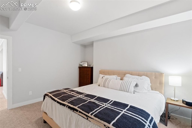 carpeted bedroom with beam ceiling