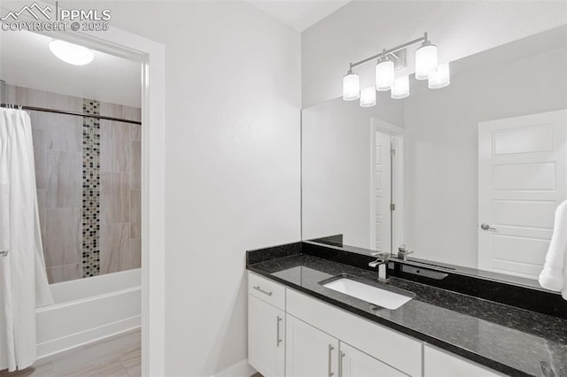 bathroom featuring shower / tub combo and vanity