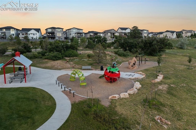 surrounding community featuring a playground and a lawn