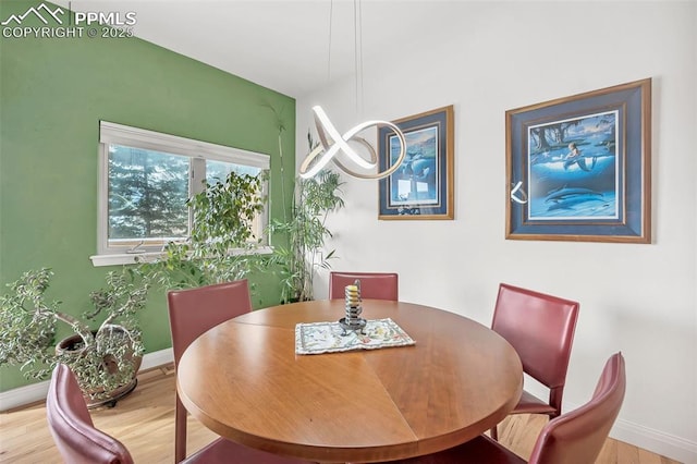 dining space with hardwood / wood-style floors