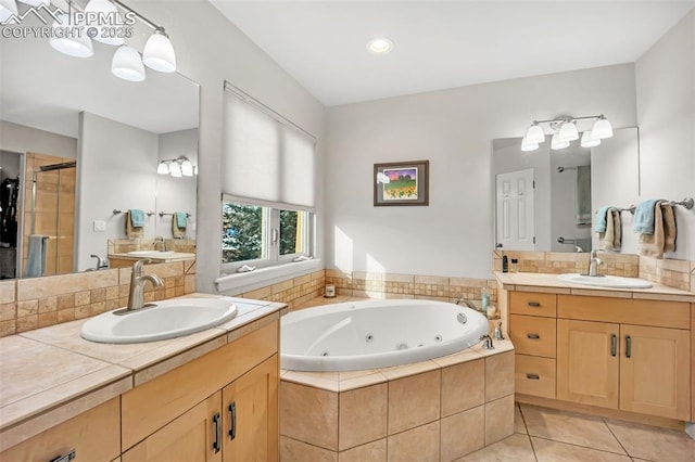 bathroom with plus walk in shower, tile patterned flooring, and vanity