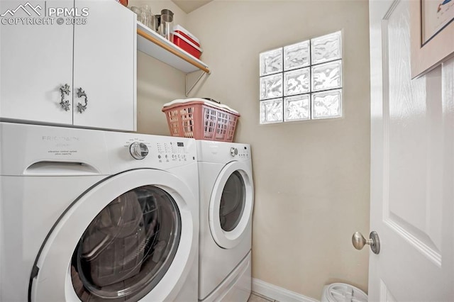 laundry room featuring cabinets and washing machine and dryer