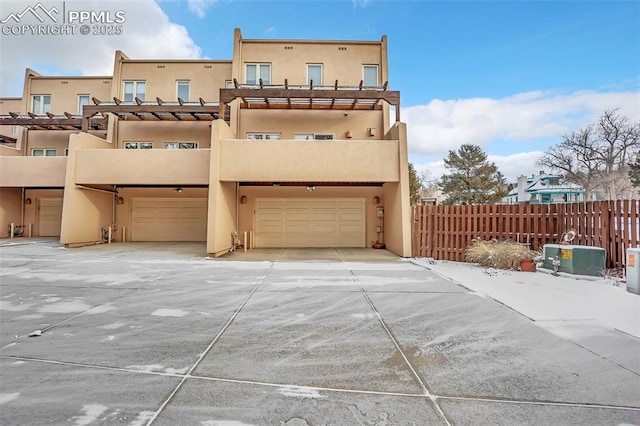 back of house featuring a balcony and a garage