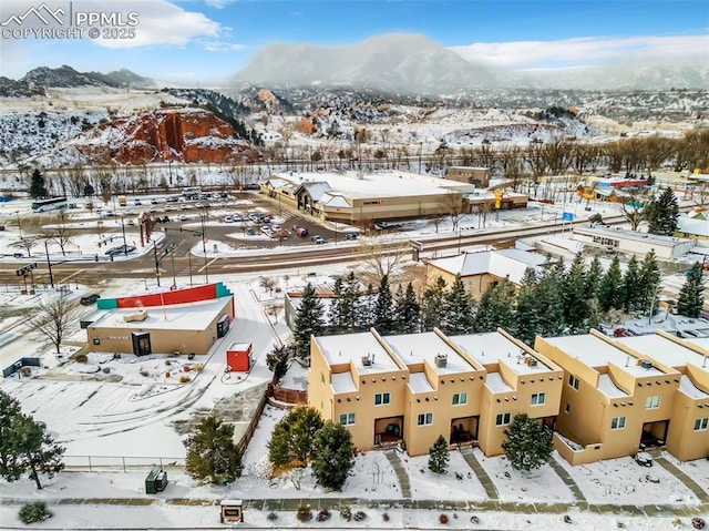 snowy aerial view with a mountain view