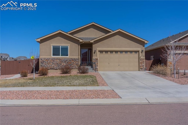 ranch-style home with stone siding, stucco siding, a garage, and concrete driveway