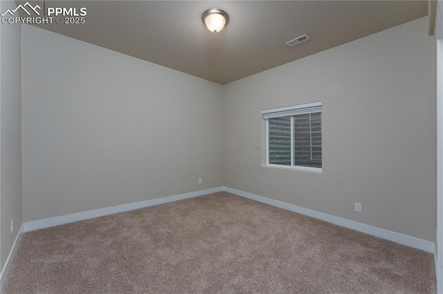 carpeted empty room with baseboards