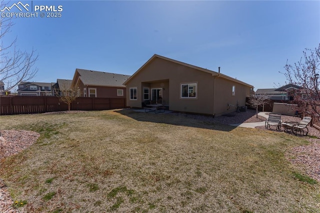 rear view of property featuring stucco siding and a patio area