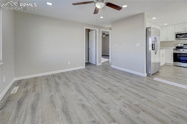 kitchen with ceiling fan, light hardwood / wood-style floors, stainless steel appliances, and white cabinetry