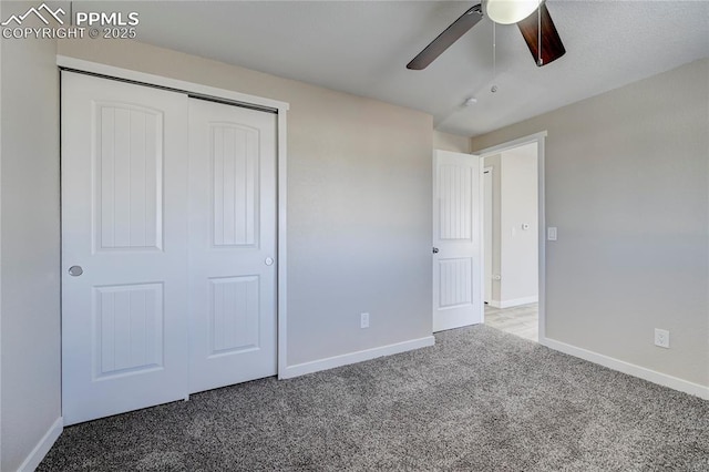 unfurnished bedroom with ceiling fan, carpet, and a closet