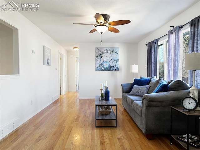 living room featuring ceiling fan and light hardwood / wood-style flooring