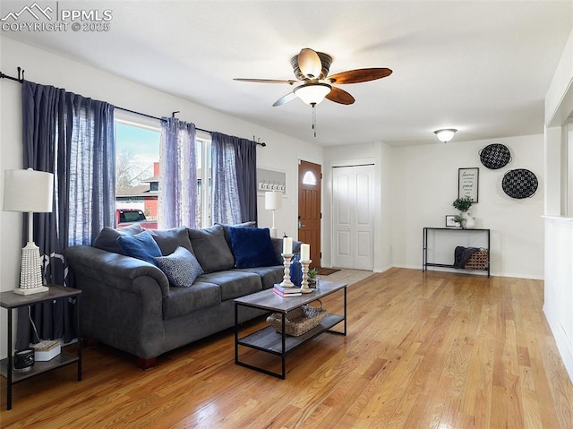 living room featuring ceiling fan and light wood-type flooring