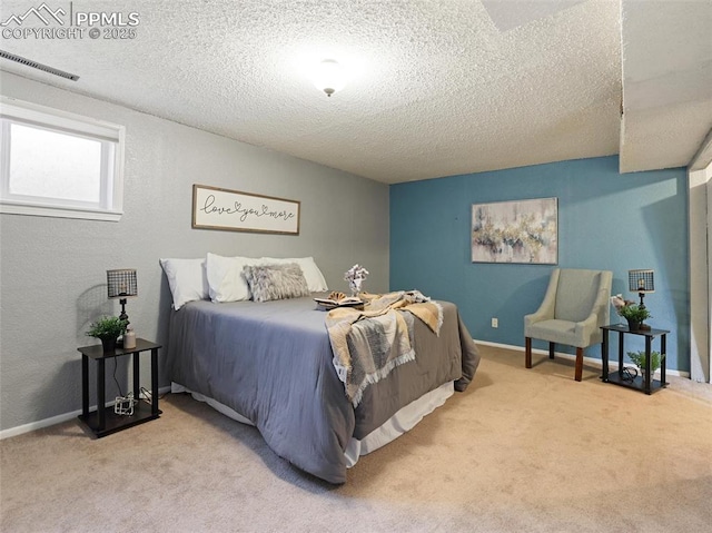 bedroom with light carpet and a textured ceiling