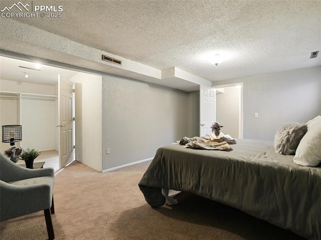 carpeted bedroom with a textured ceiling and a closet