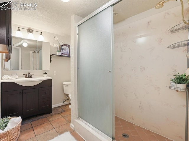 bathroom with toilet, vanity, tile patterned flooring, a shower with shower door, and a textured ceiling